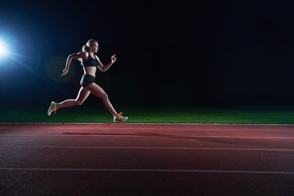 Athletic woman running onrace  track