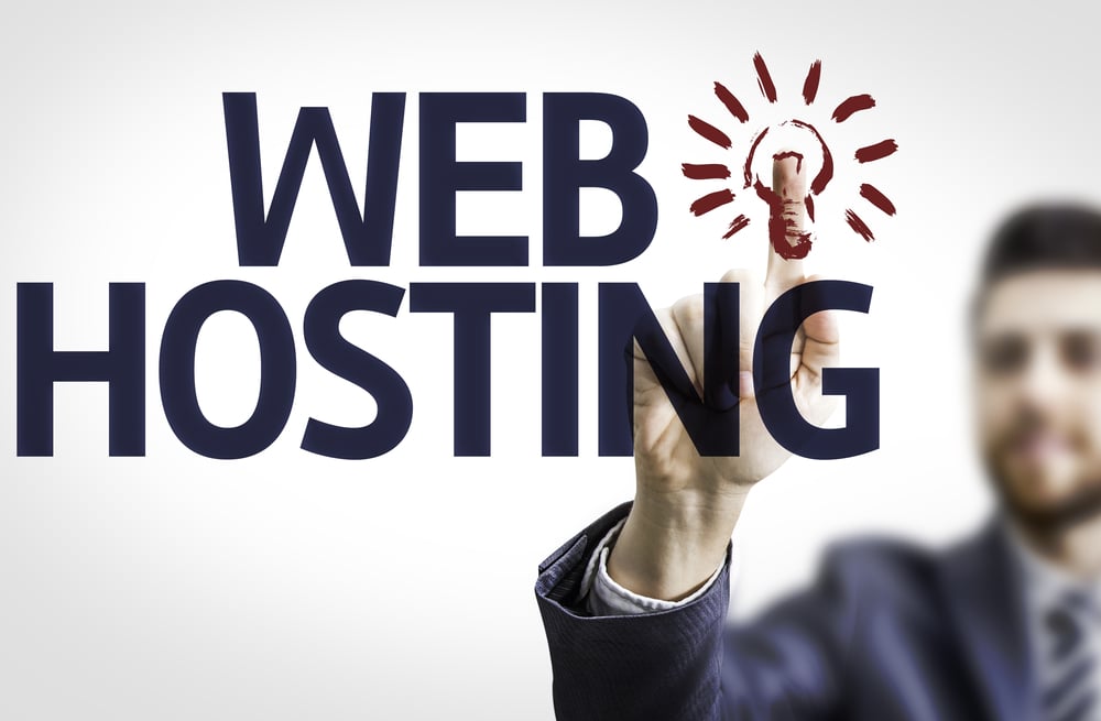 Business man pointing to transparent board with text Web Hosting
