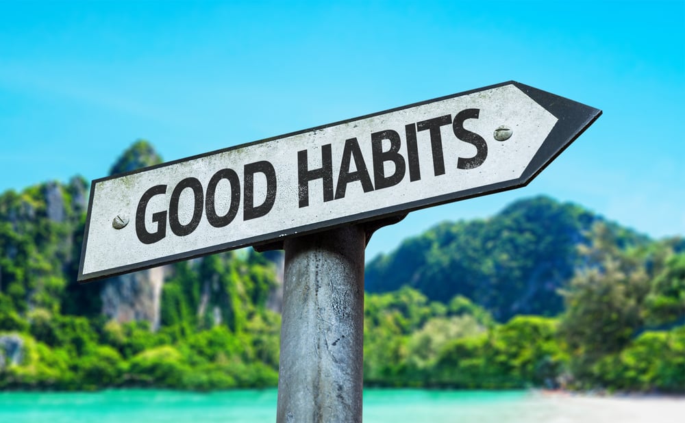 Good Habits sign with a beach on background
