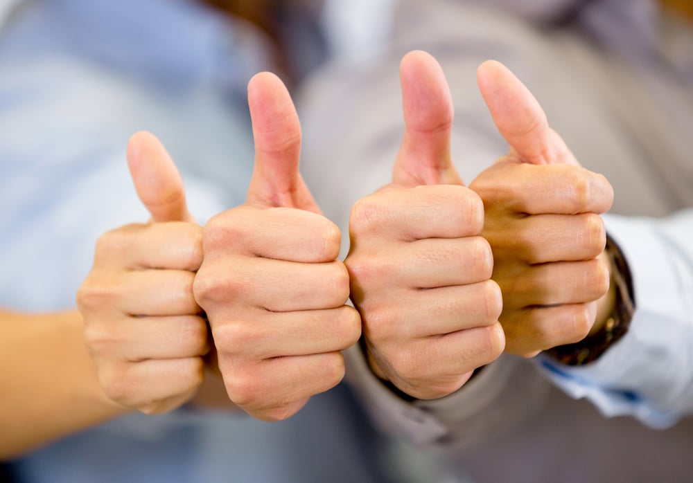 Group of hands with thumbs up expressing positivity