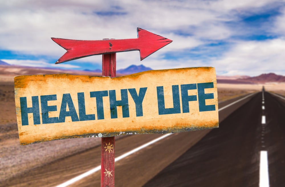 Healthy Life sign with road background