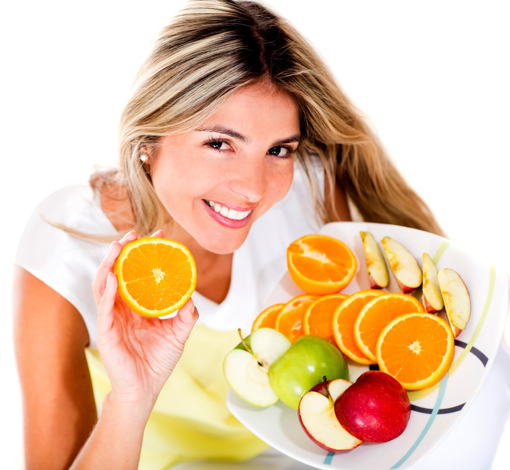 Healthy eating woman holding a tray of fruits - isolated over white