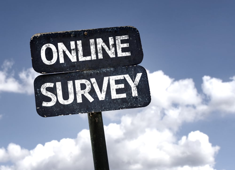 Online Survey sign with clouds and sky background