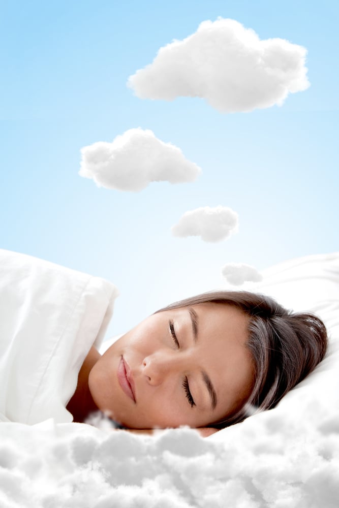 Peaceful woman sleeping on a cloud and having sweet dreams