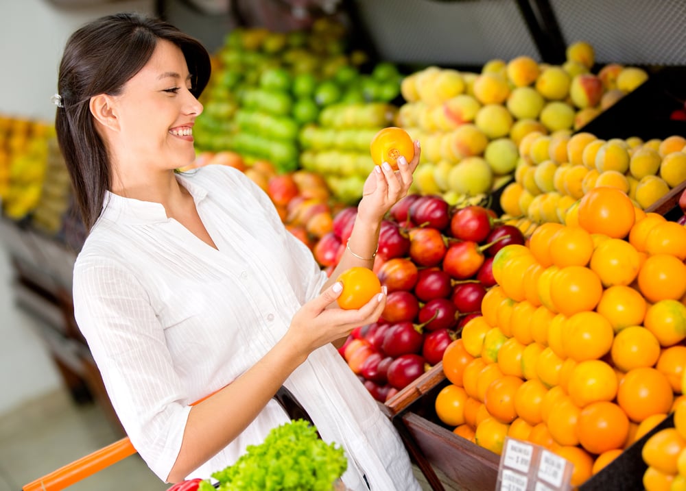 Woman buying fresh fruit at the supermarket