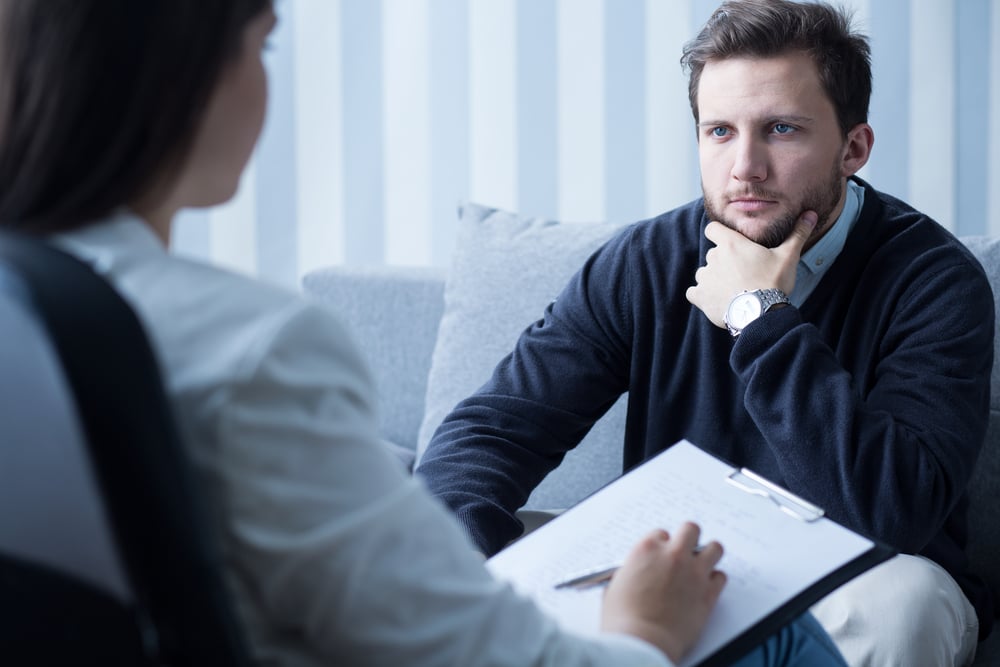 Young man during therapy at psychologists office-1